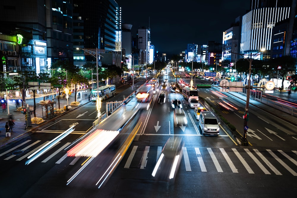 a city street filled with lots of traffic at night