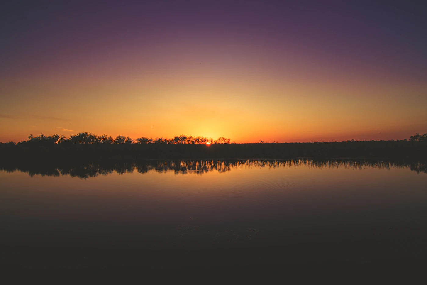 Sunset over still water in the Everglades. Quiet places like this are easy to reach from Homestead.