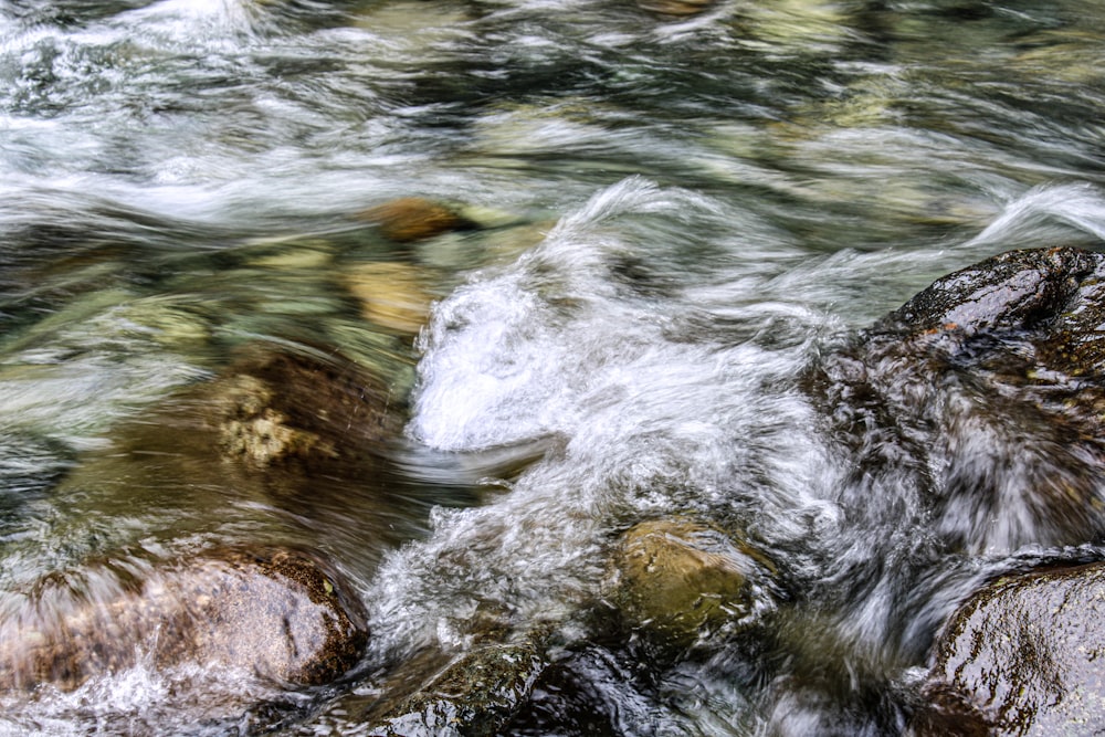 a close up of a river with rocks and water