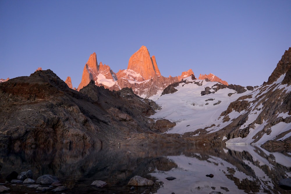 a mountain range with a lake in the foreground