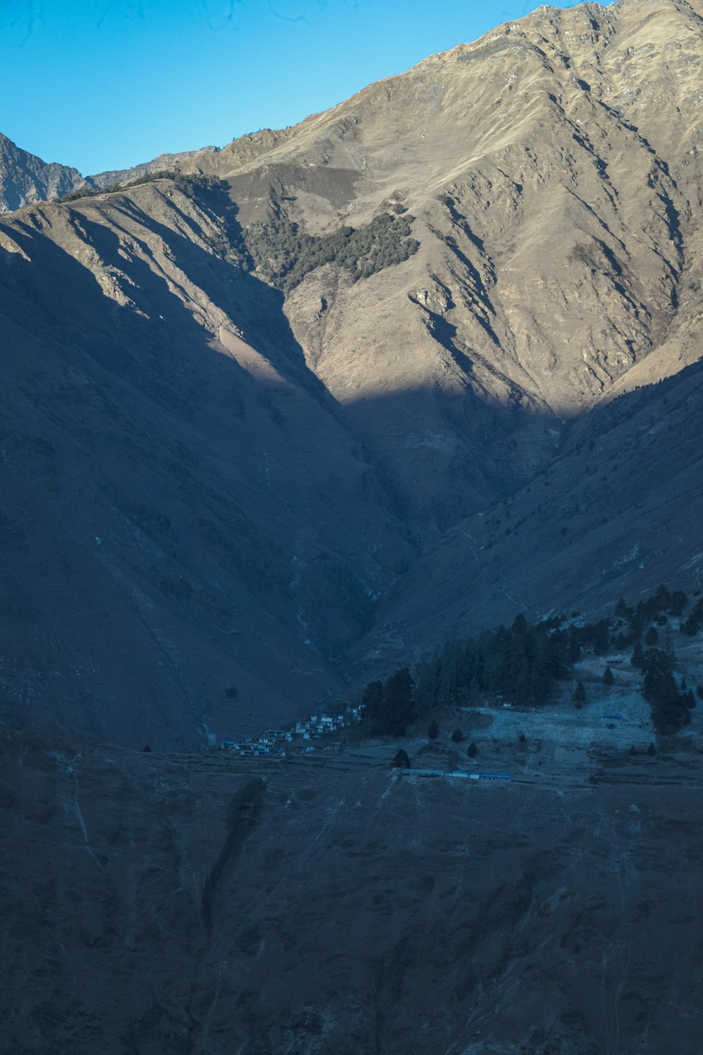 a view of a valley with mountains in the background