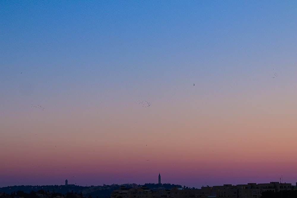 a view of a city skyline at sunset