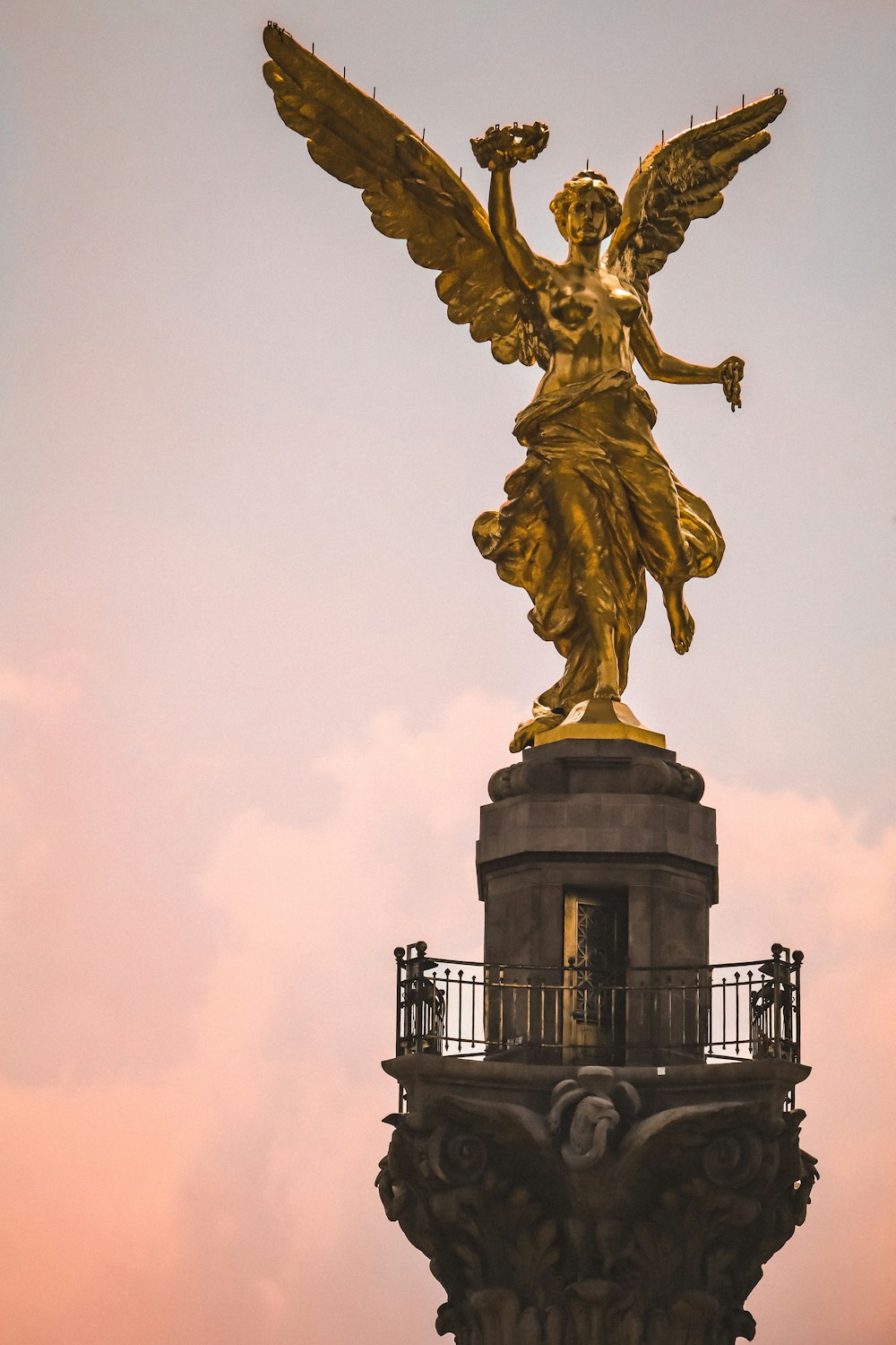 a statue of an angel on top of a building