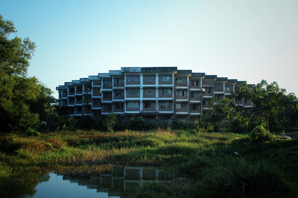 a large building sitting on top of a lush green field