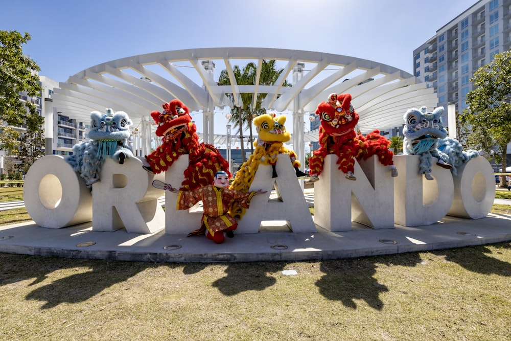 a group of stuffed animals standing in front of a sign