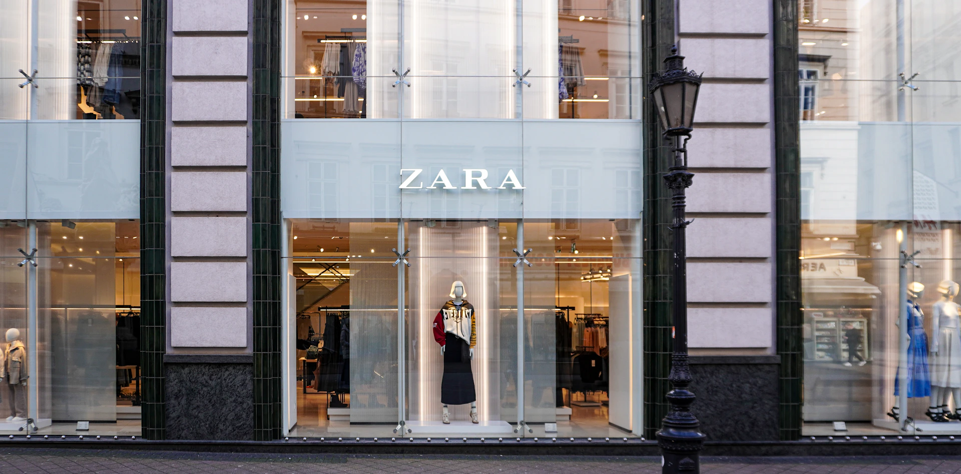 a store front with mannequins in the windows