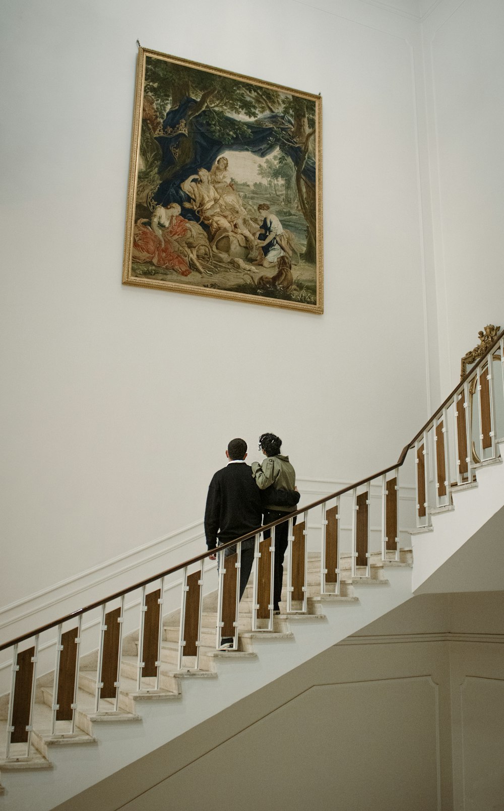 two people walking up a set of stairs