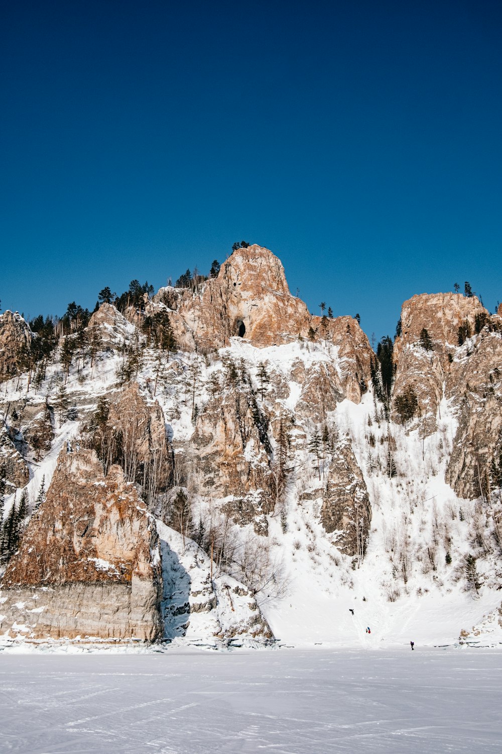 a group of people riding skis on top of a snow covered slope