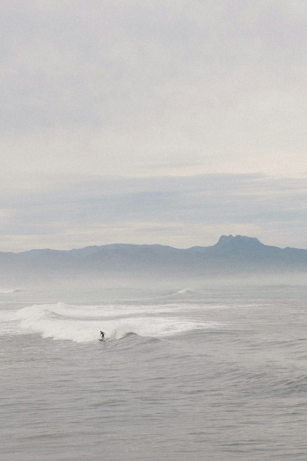 a person riding a surfboard on a wave in the ocean