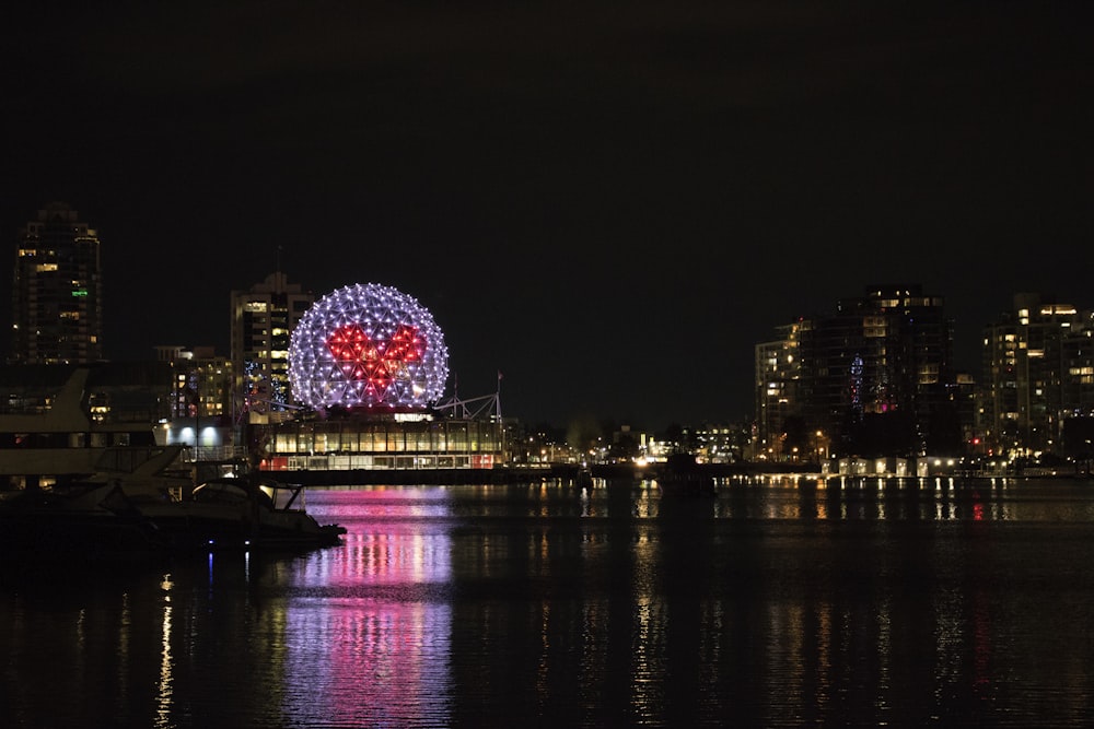 a ferris wheel in the middle of a city at night