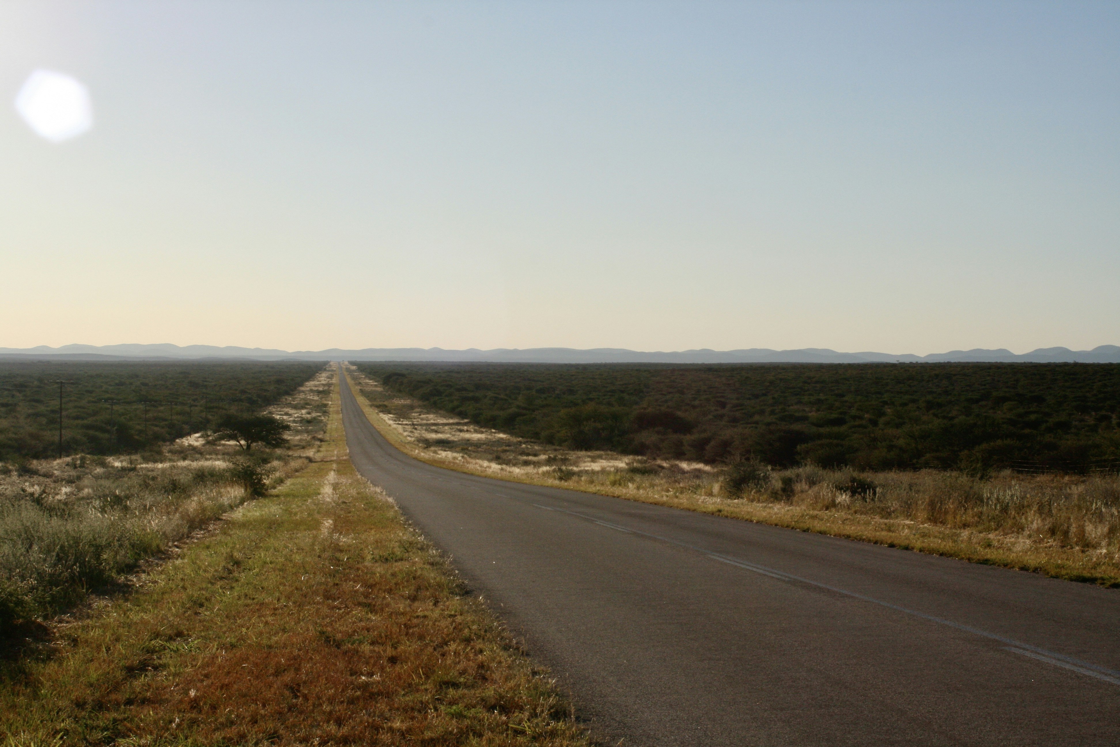 a long straight road in the middle of the desert