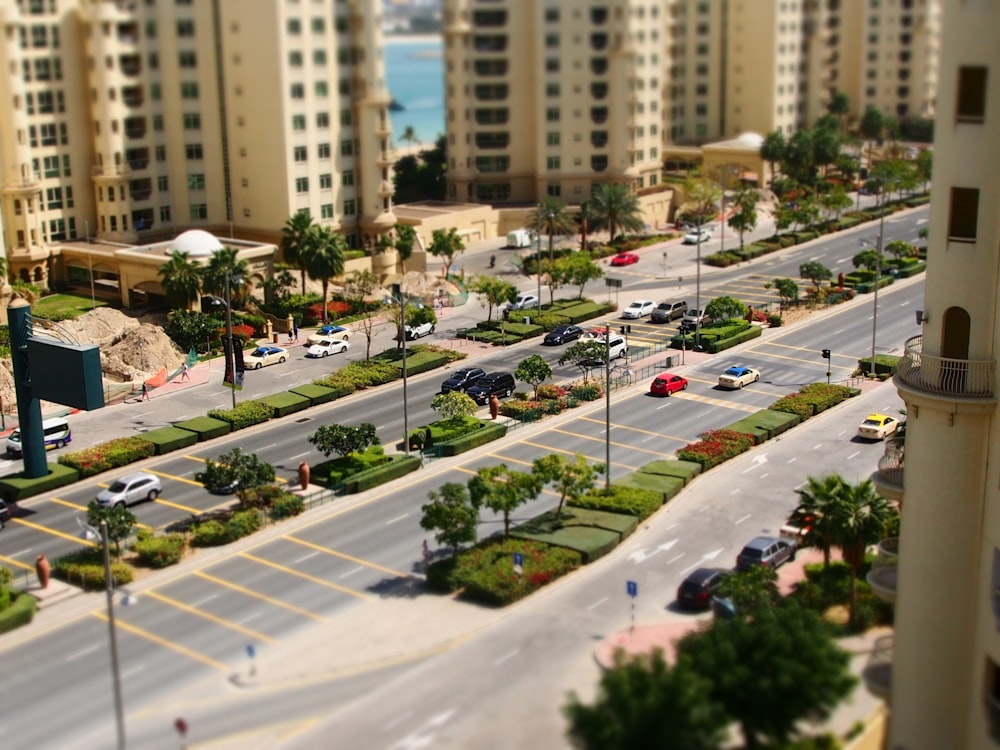 a city street filled with lots of traffic next to tall buildings