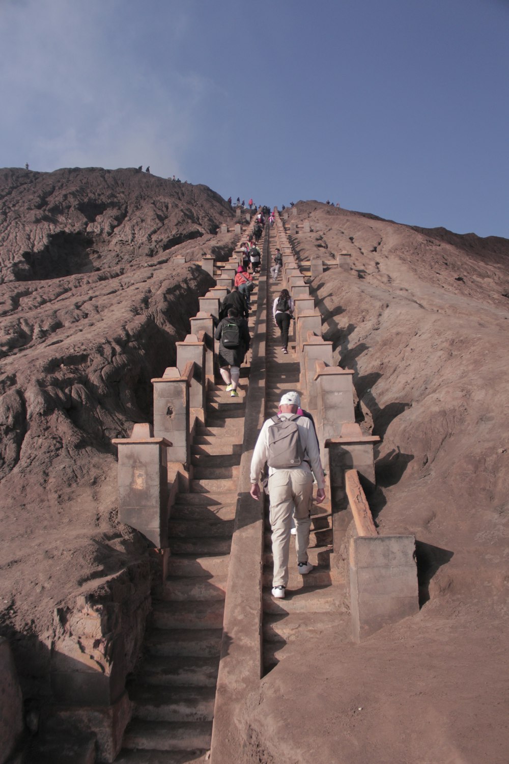 a group of people walking up a set of stairs