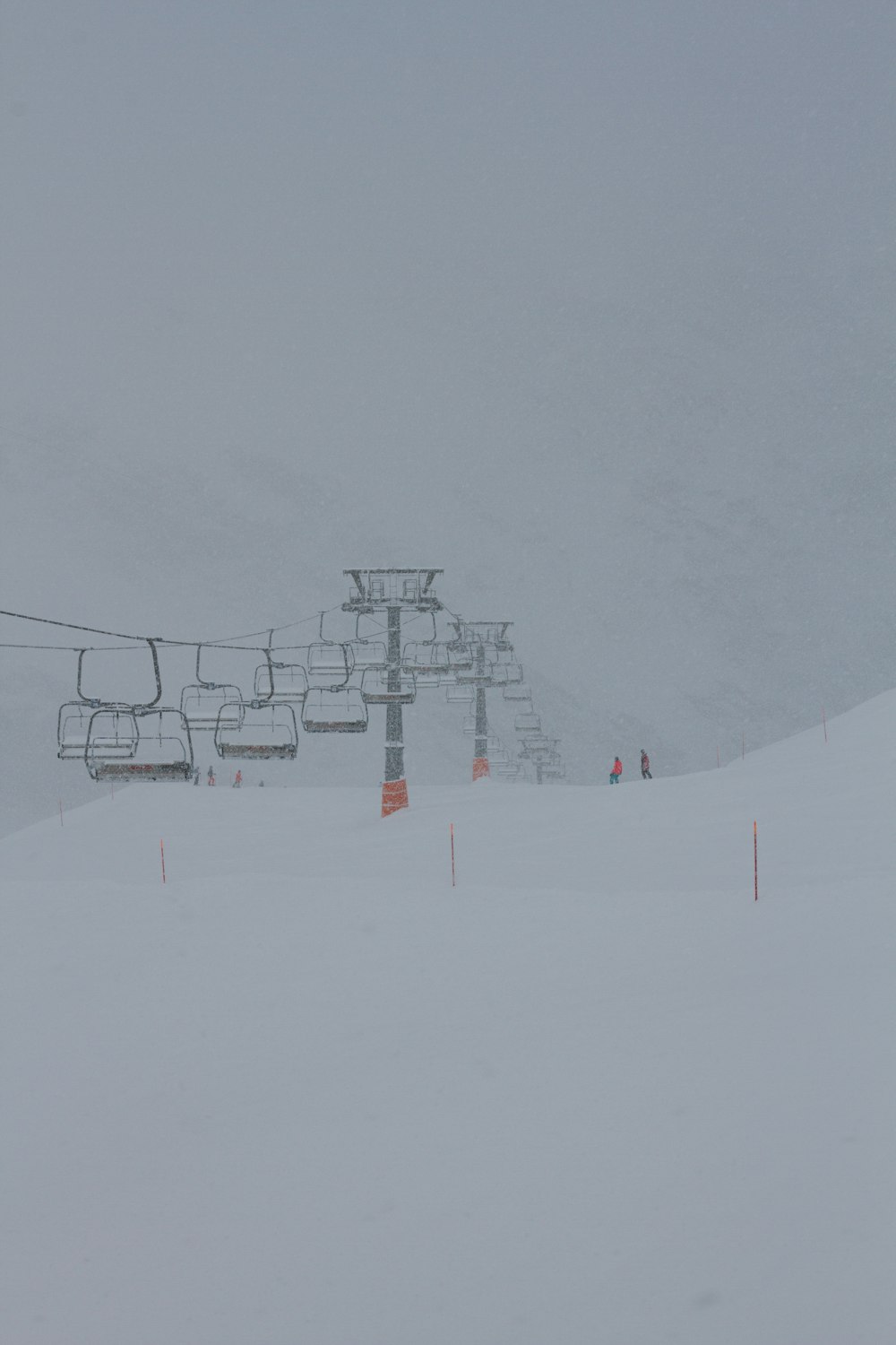 a ski lift going up a snowy mountain