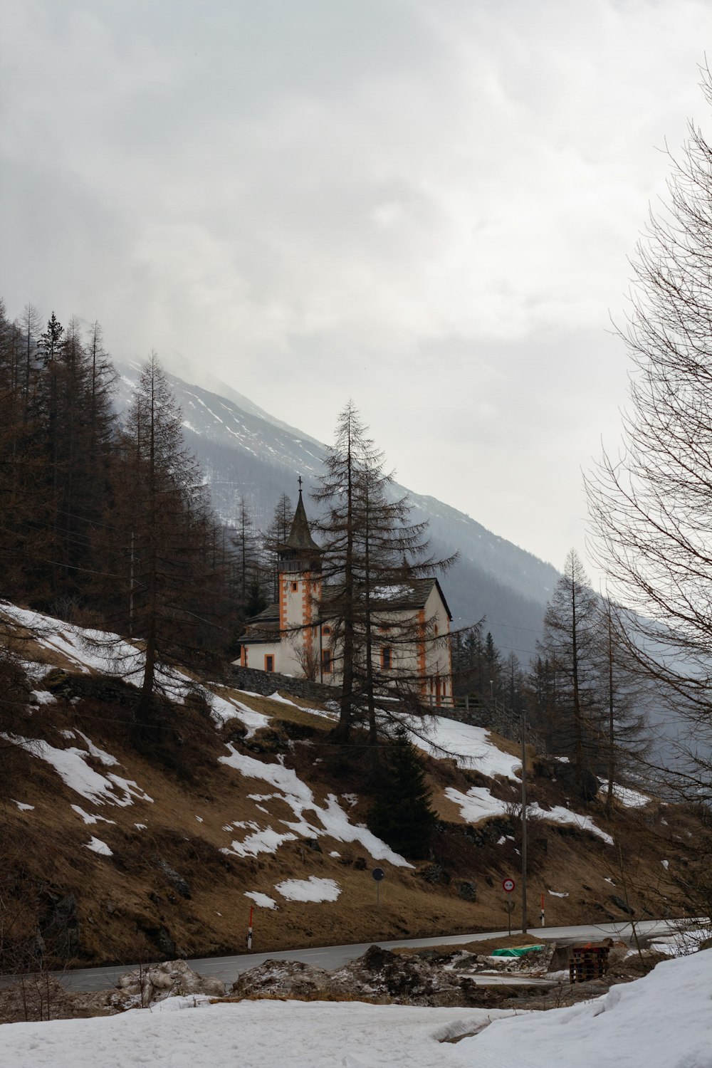 a house on a hill with snow on the ground