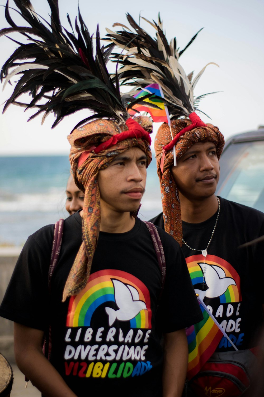 two young men wearing headdress standing next to each other