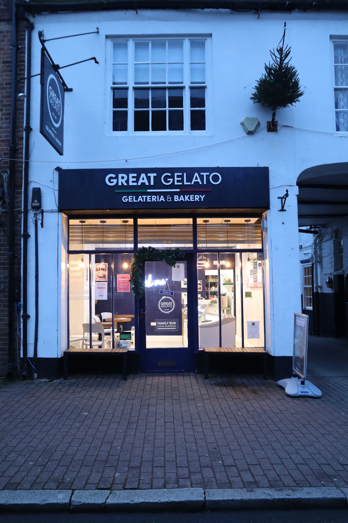 A painted shopfront sign advertising gelato above a doorway