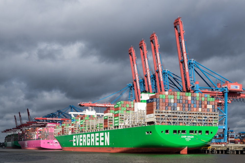 a large green cargo ship in a harbor