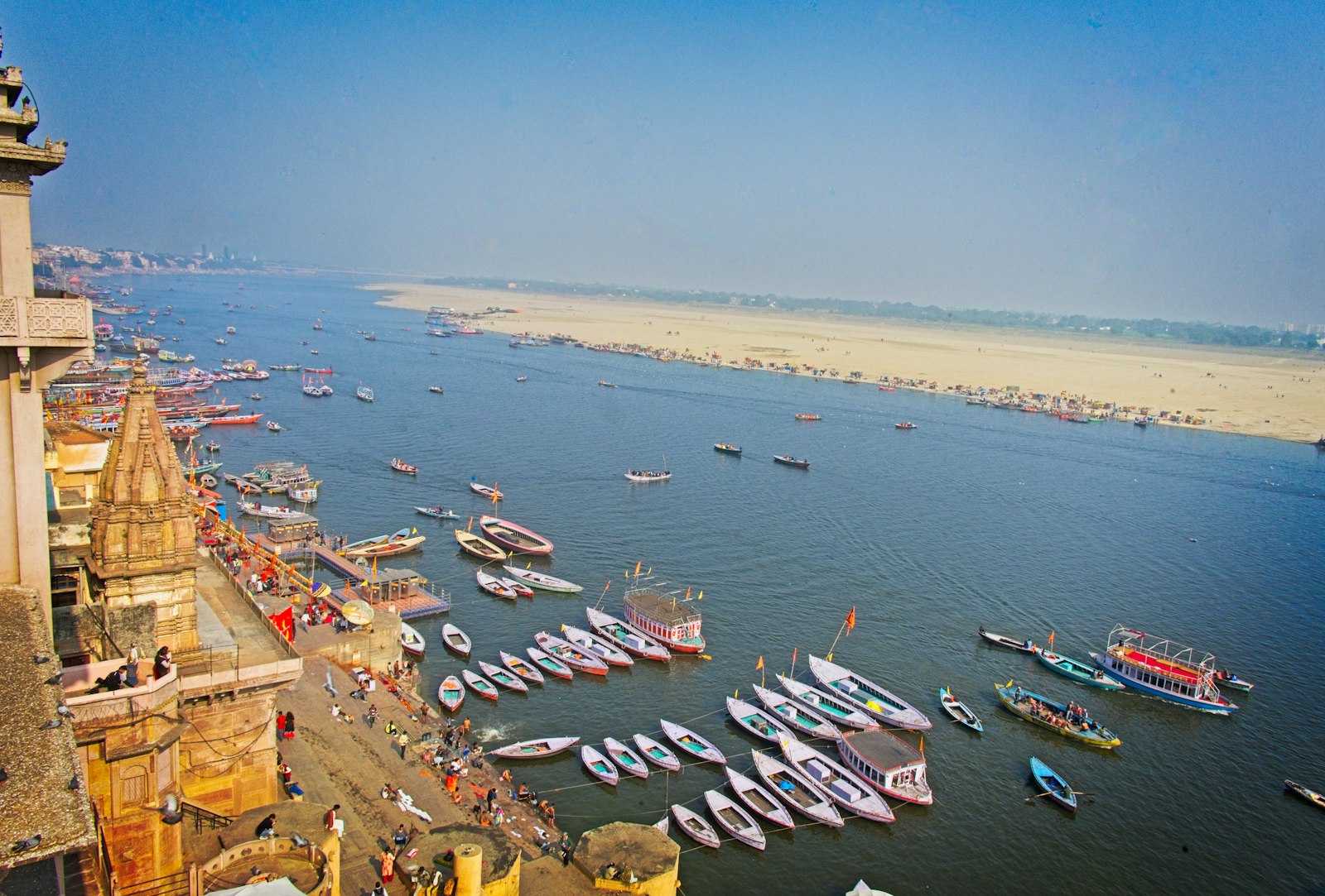 Wooden boats moored along the ghats of the Ganges in Varanasi, seen from above