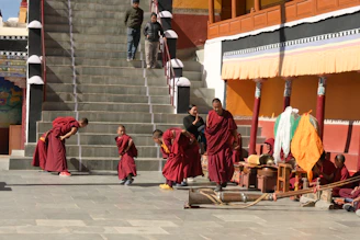 a group of monks walking up a flight of stairs
