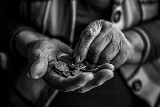 a person holding a handful of coins in their hands