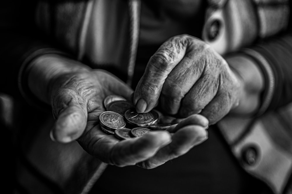 une personne tenant une poignée de pièces de monnaie dans ses mains