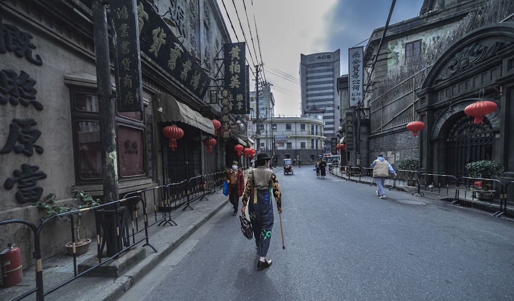 a person walking down a street with a scooter