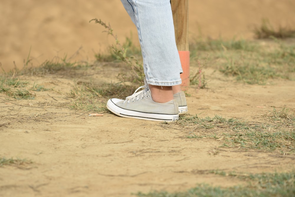 a person standing on top of a dirt field