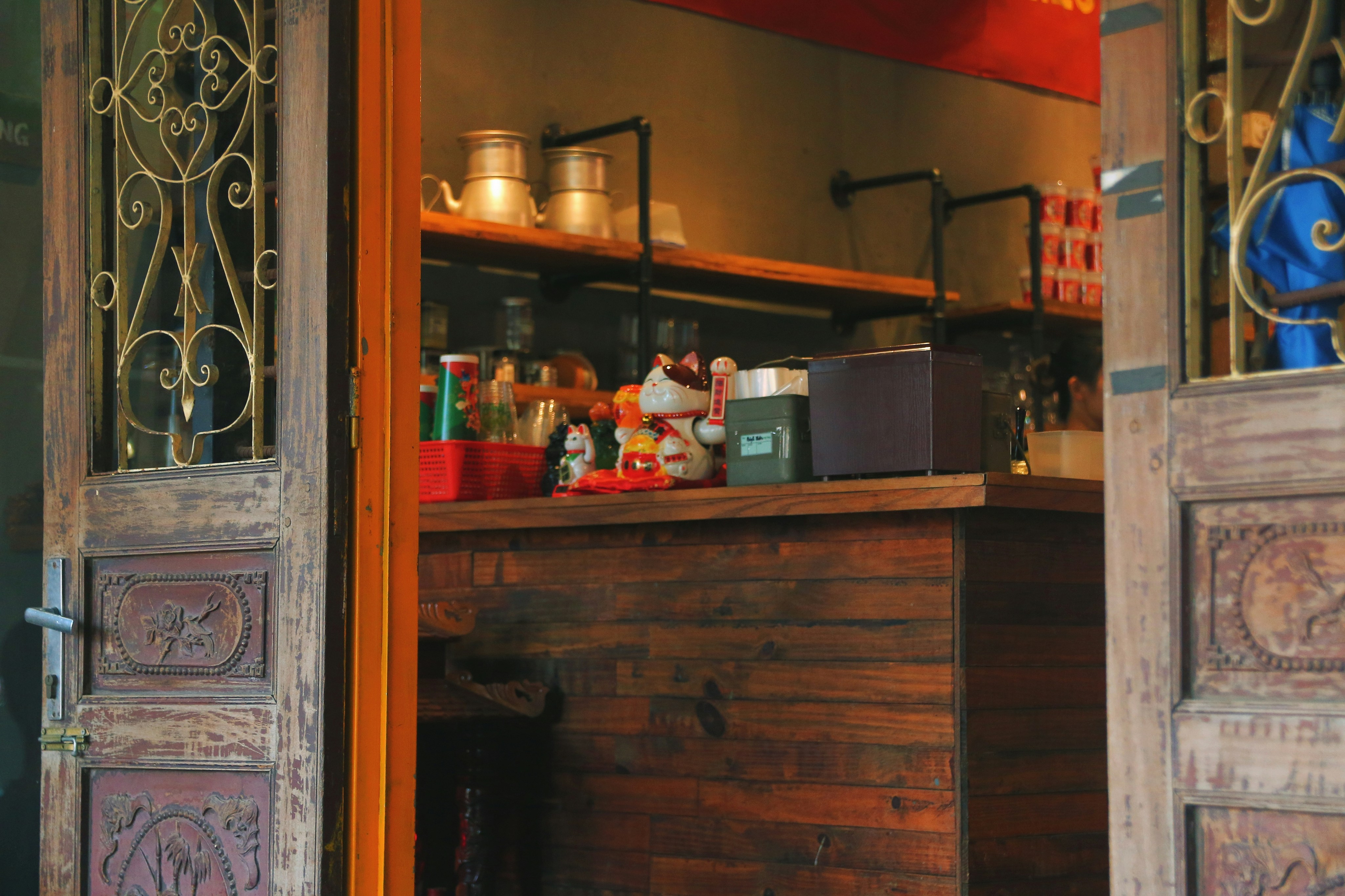 an open door to a store filled with items