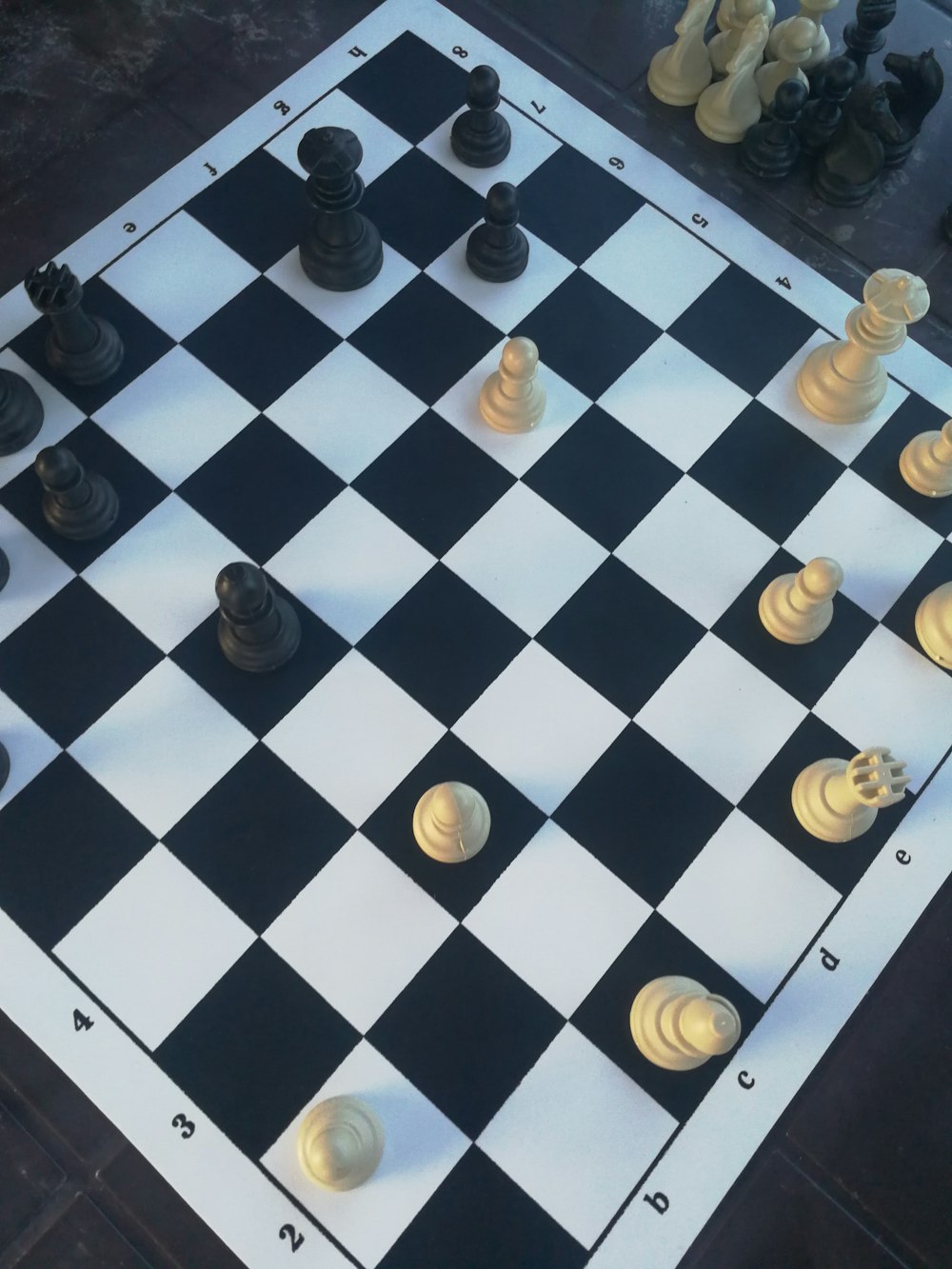 a black and white chess board with chess pieces on it