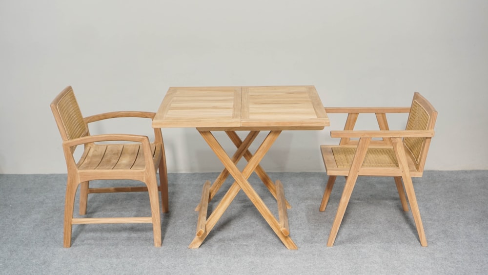 a wooden table and chairs sitting next to each other