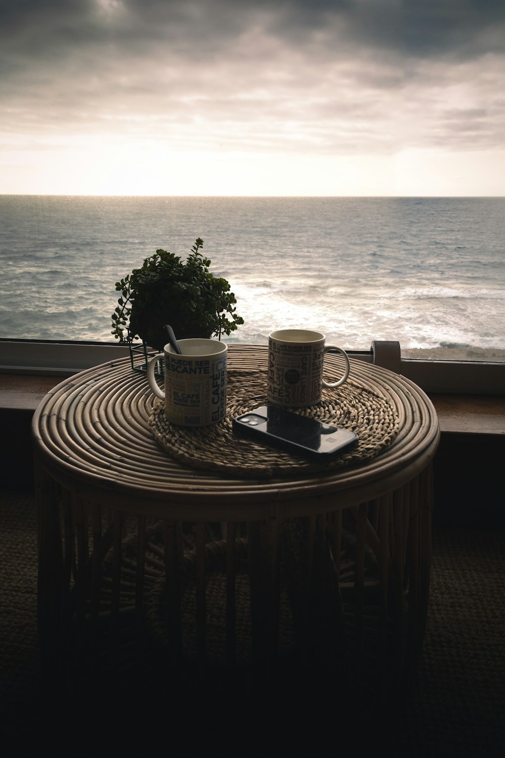 a table with a cup of coffee and a book on it