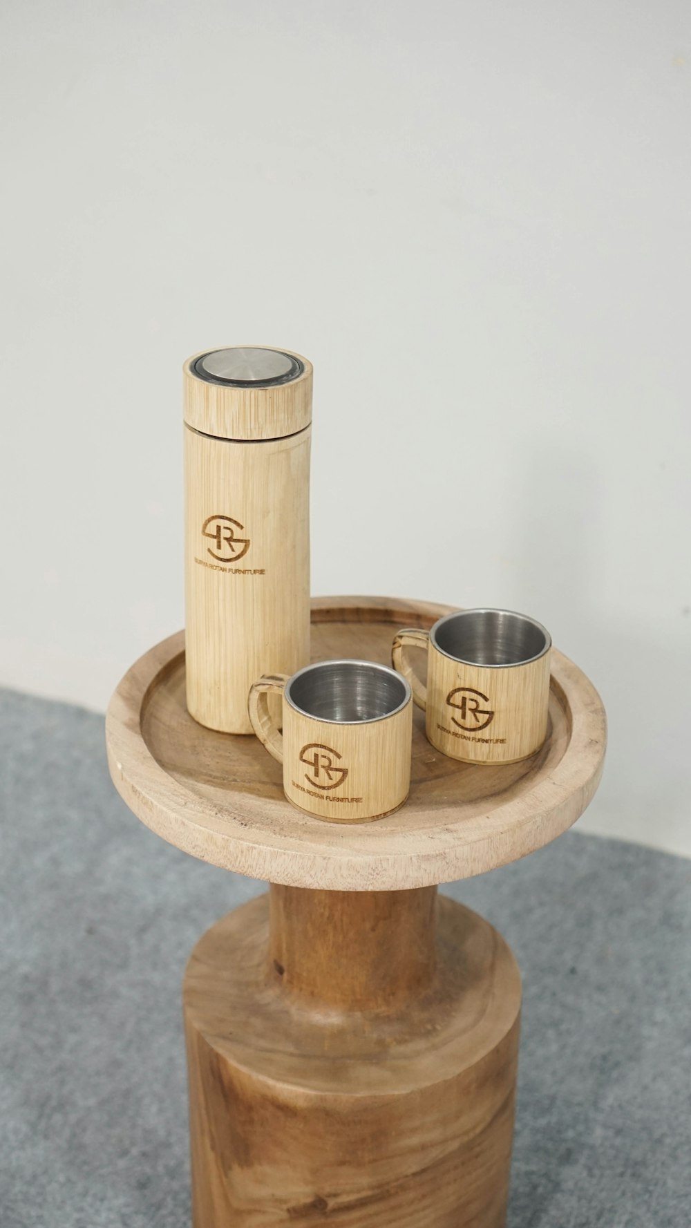 a couple of cups sitting on top of a wooden stand