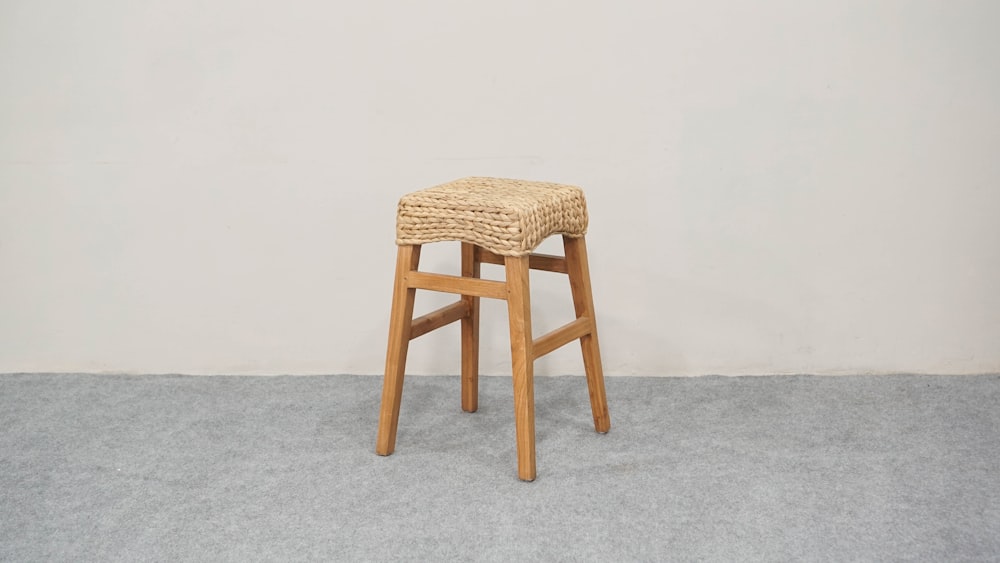 a wooden stool with a woven seat