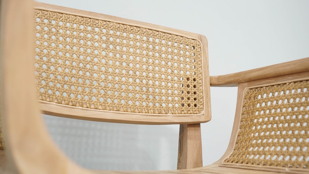 a close up of a wooden chair with a mirror in the background