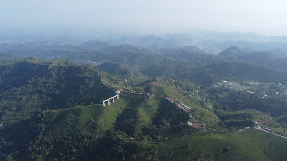 an aerial view of a mountain with a bridge on it