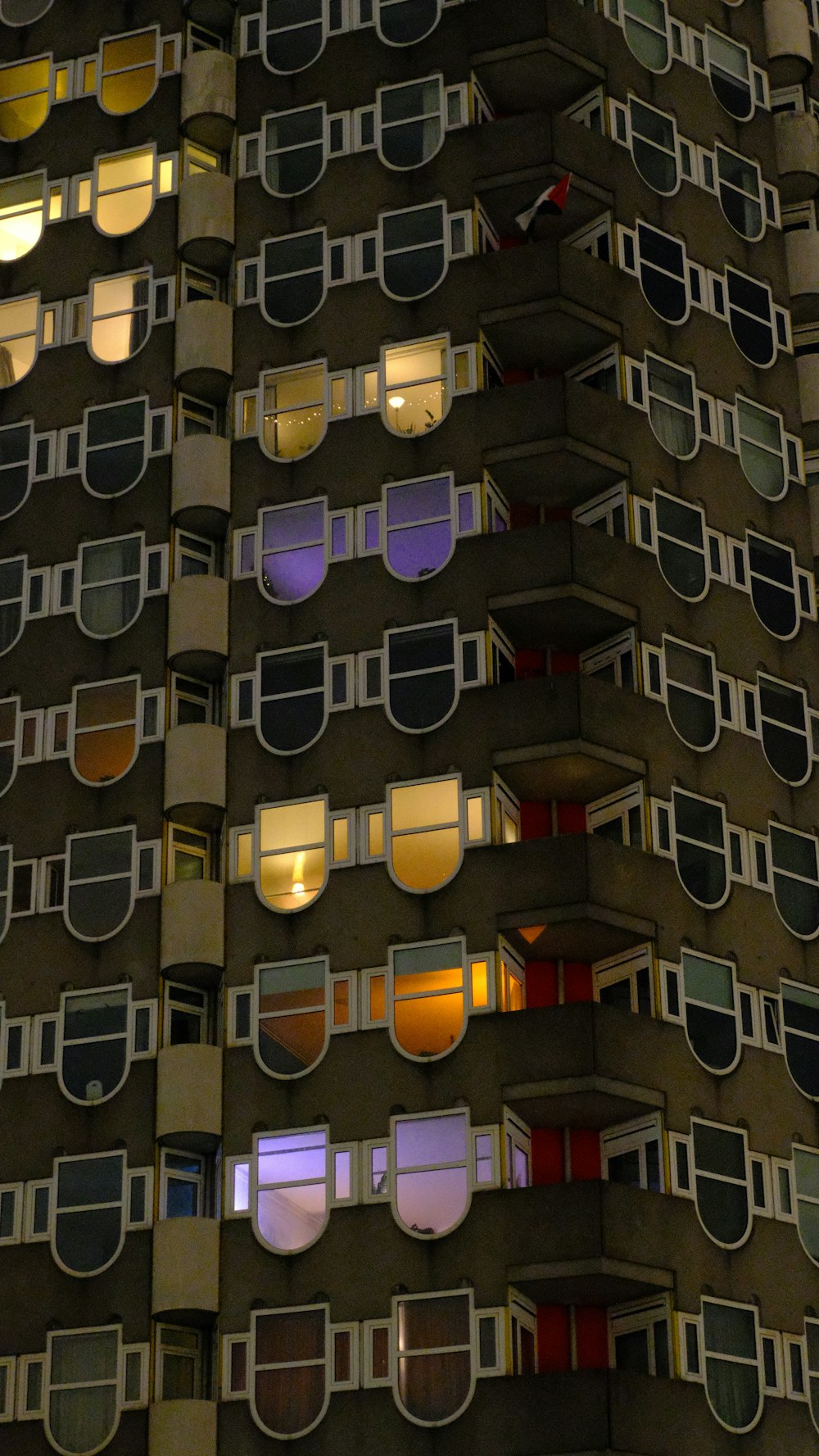 a very tall building with many windows at night