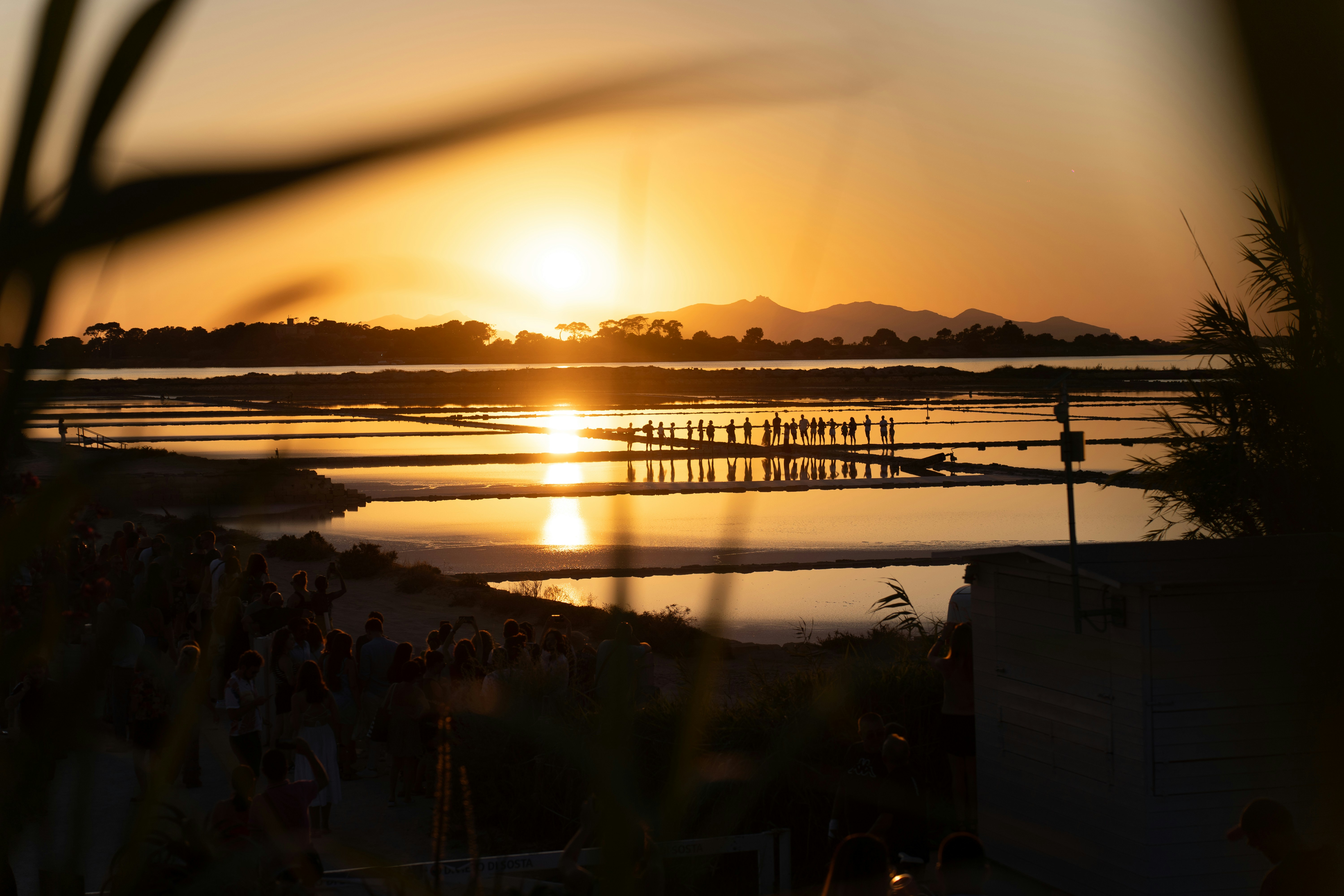 the sun is setting over a body of water