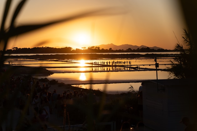 the sun is setting over a body of water