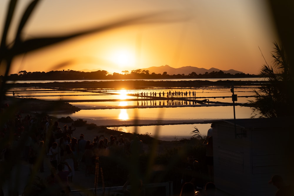 the sun is setting over a body of water