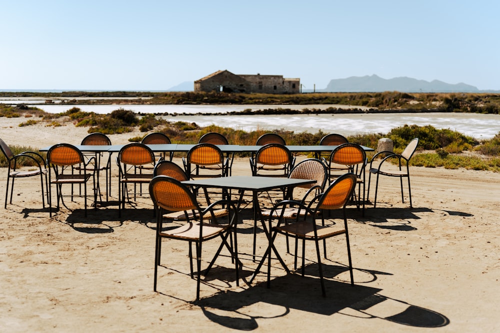 a bunch of chairs that are sitting in the sand