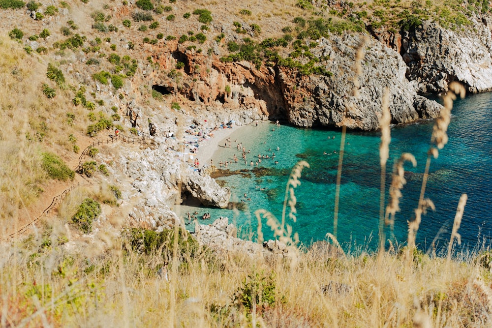 a body of water surrounded by a rocky cliff