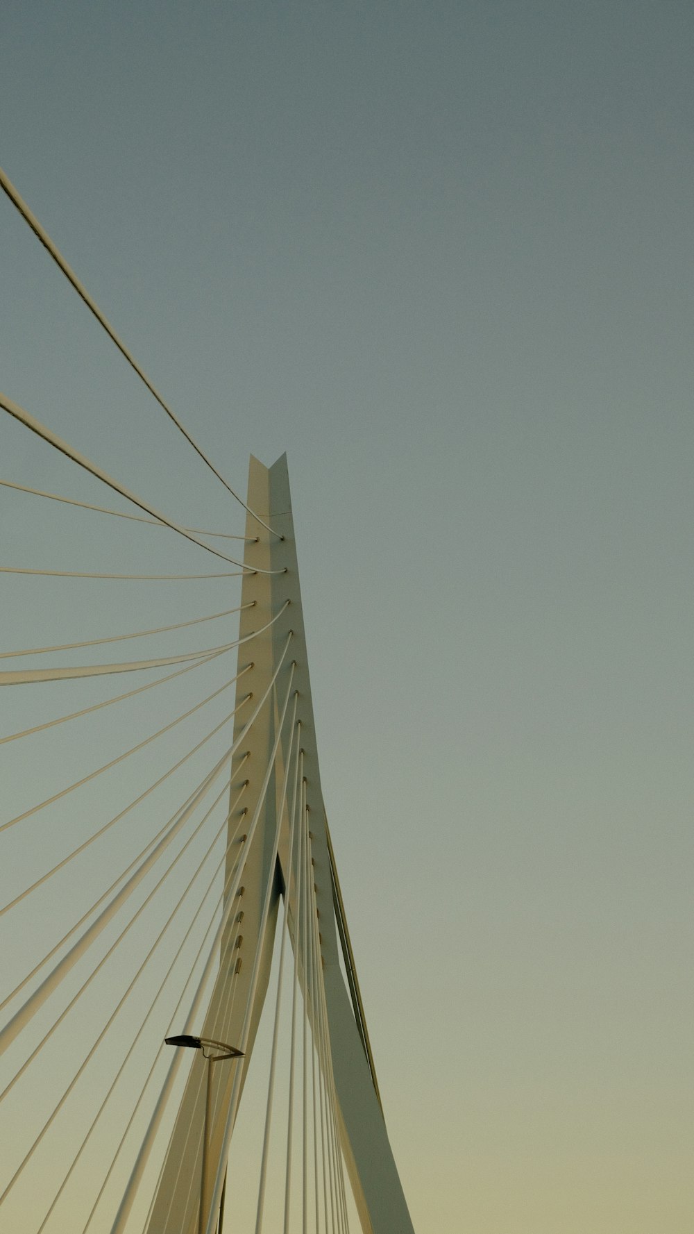 a tall white bridge with a sky background