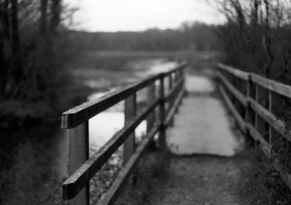 a black and white photo of a bridge over a river