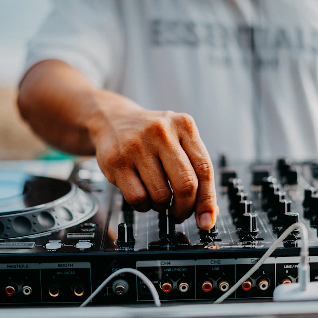 A DJ mixing a track on a turntable