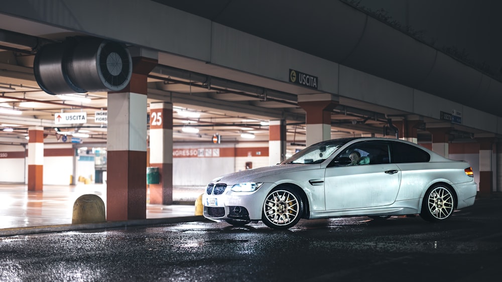 a white car parked in a parking garage