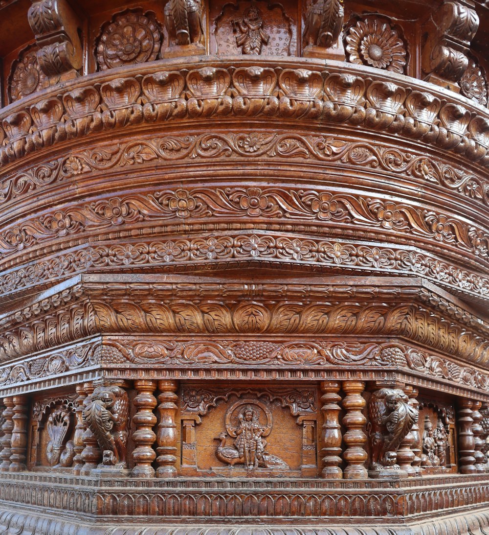 a carved wooden structure with carvings on it