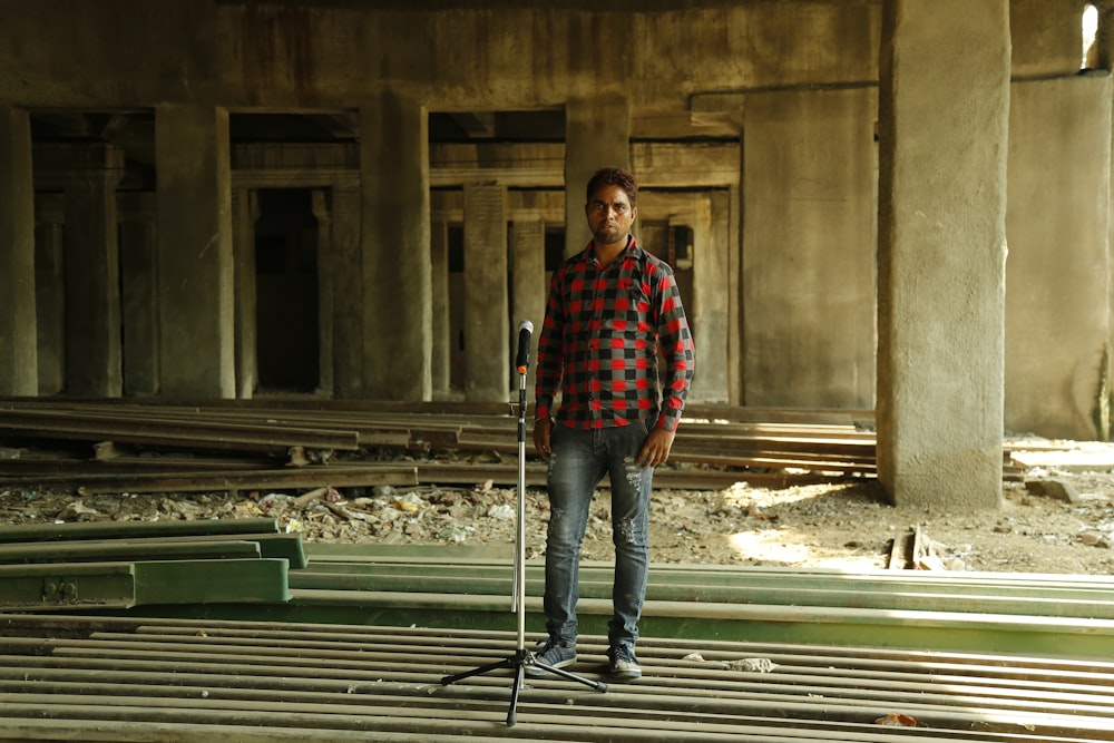 a man standing in a building with a pair of skis