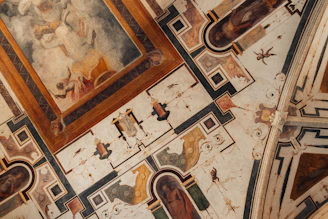 the ceiling of a building with paintings on it