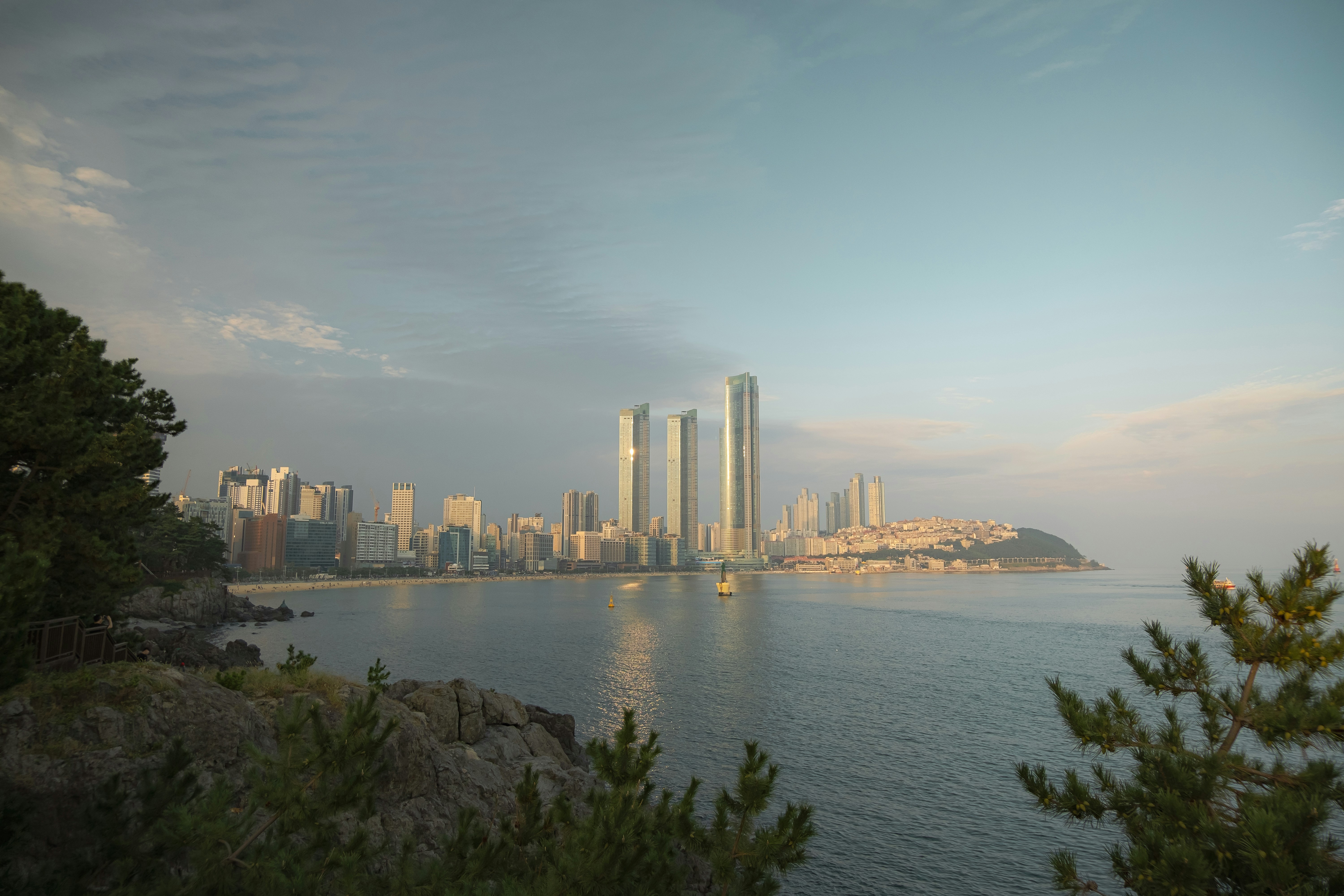 Busan city coastal view with ocean and buildings at sunset